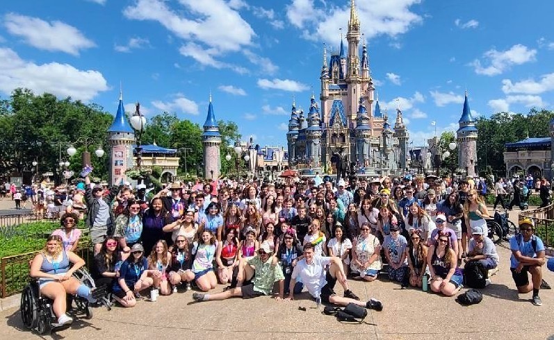 large group of students in front of Disney Castle