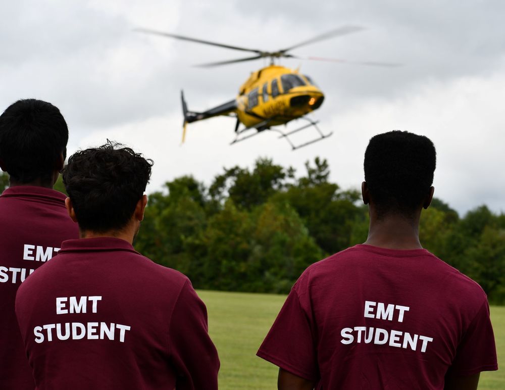 AirCare6 Helicopter landing as CTEC EMT students look on 