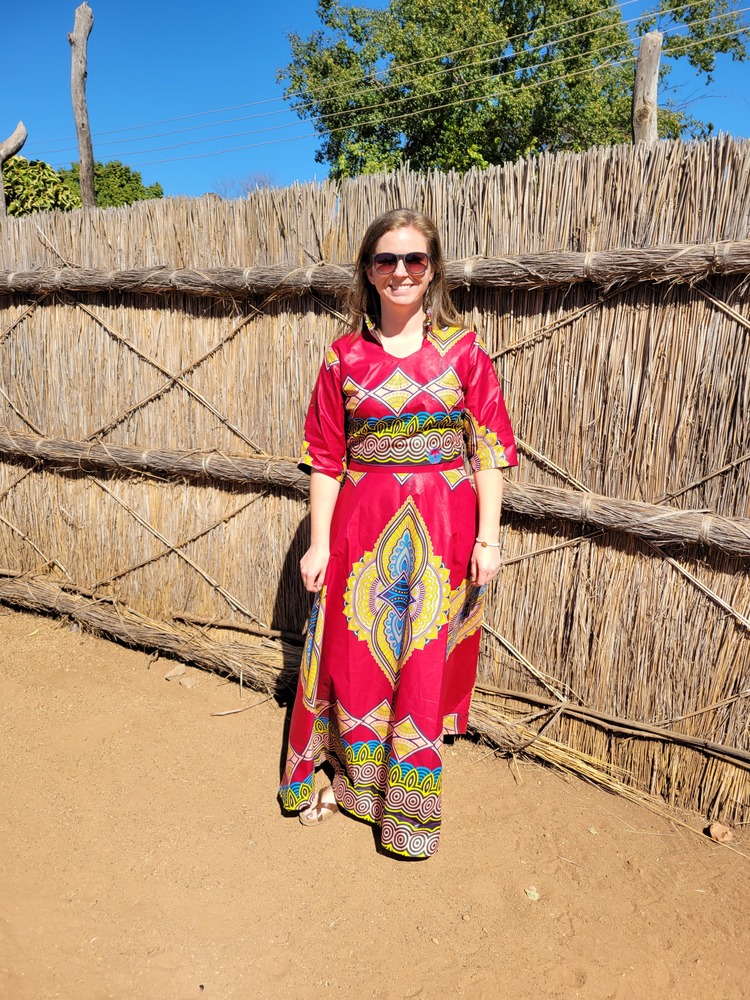 teacher in red outfit in Africa