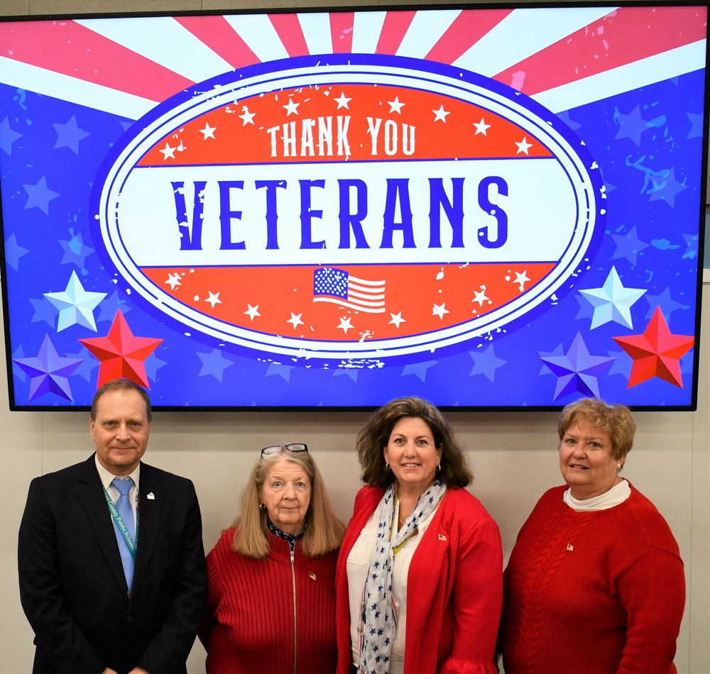 Superintendent and School Board with Thank You Veterans sign
