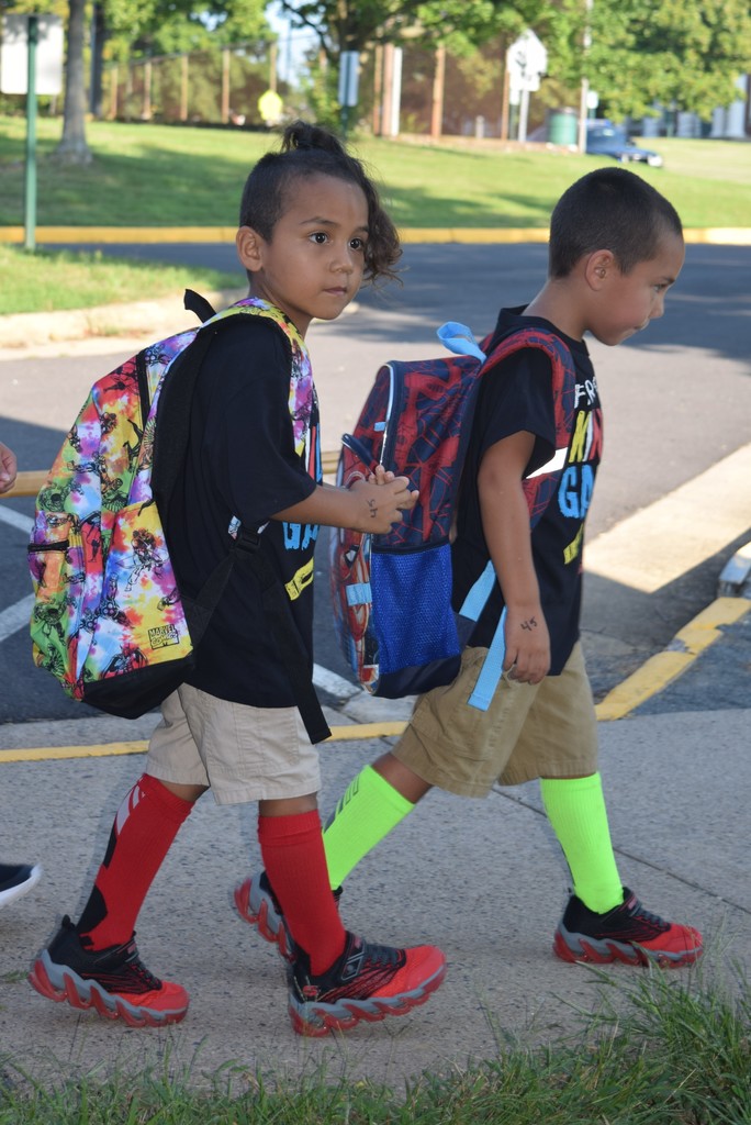 twins walking to kindergarten