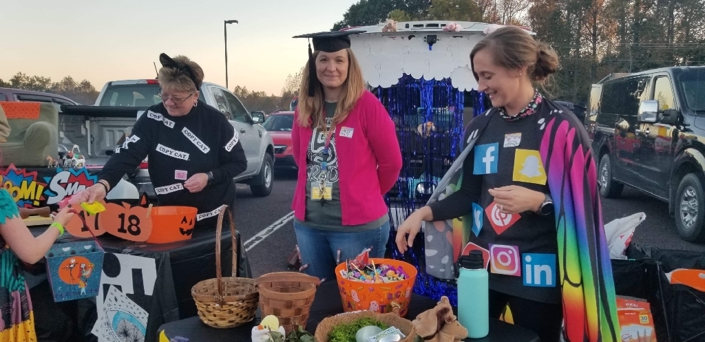 Teachers in costume at trunk or treat