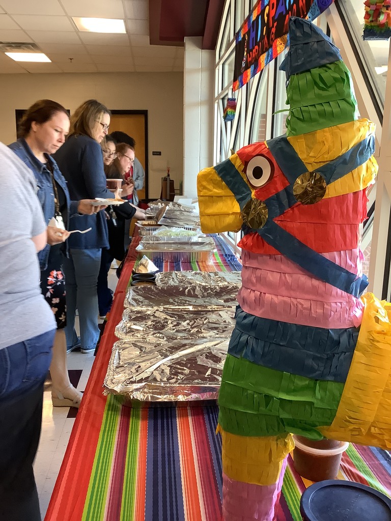 A picture of a pinata and the spread of food served to staff members