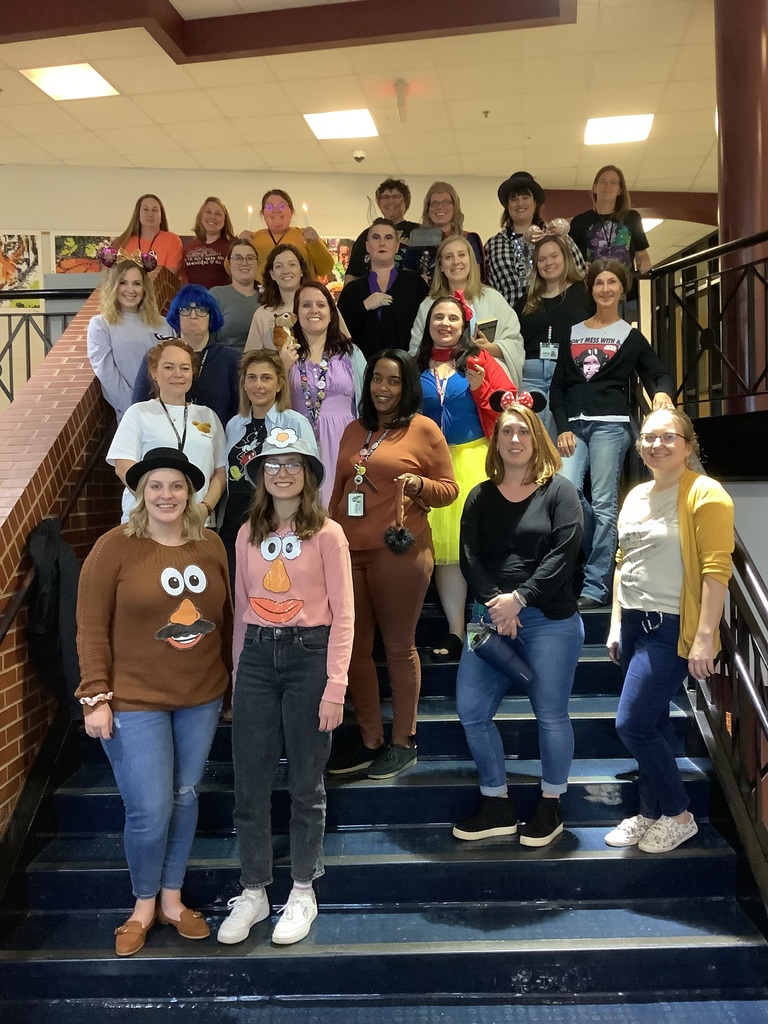 A picture of the FTB teachers dressed as Disney characters in the stair well. 