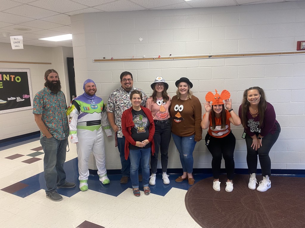 A picture of the 8th grade teachers dressed as Disney characters in the hallway