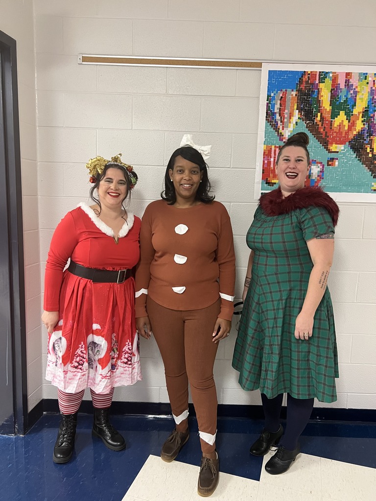 A picture of 3 teachers, each dressed as different characters