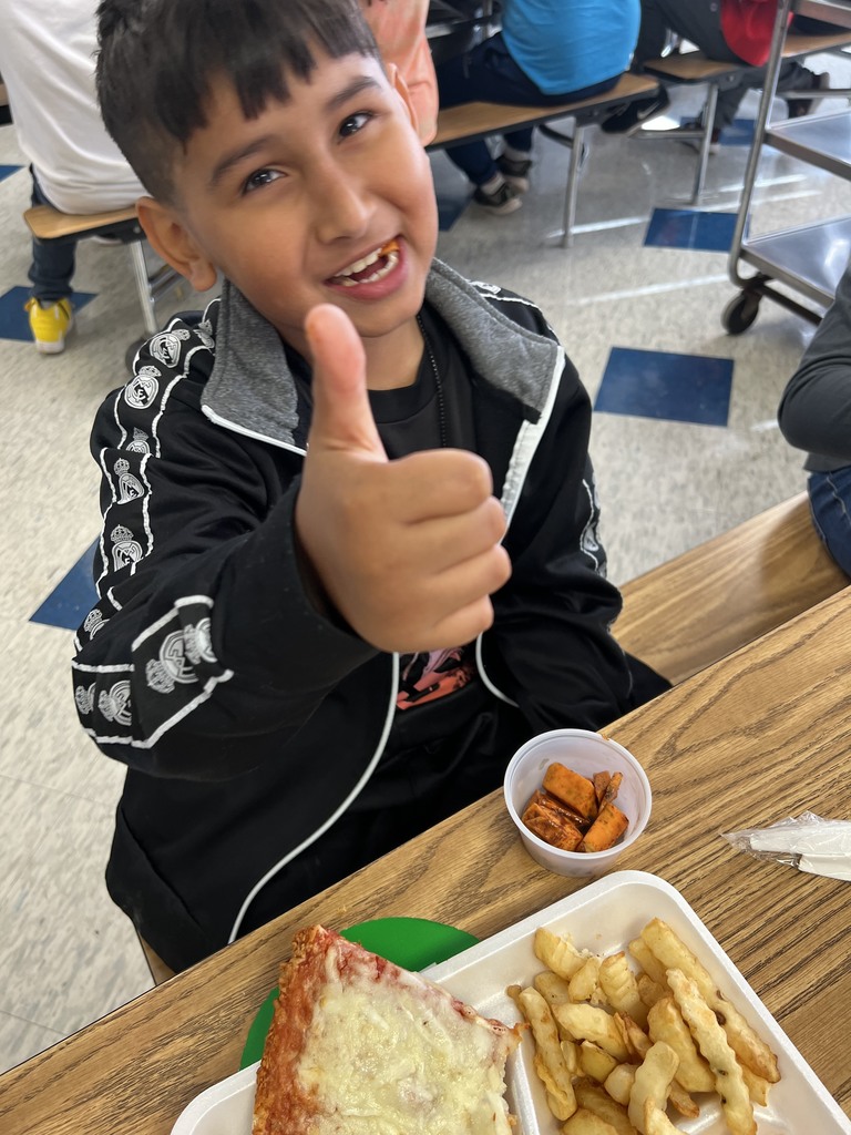 student giving thumbs up to sweet potatoes