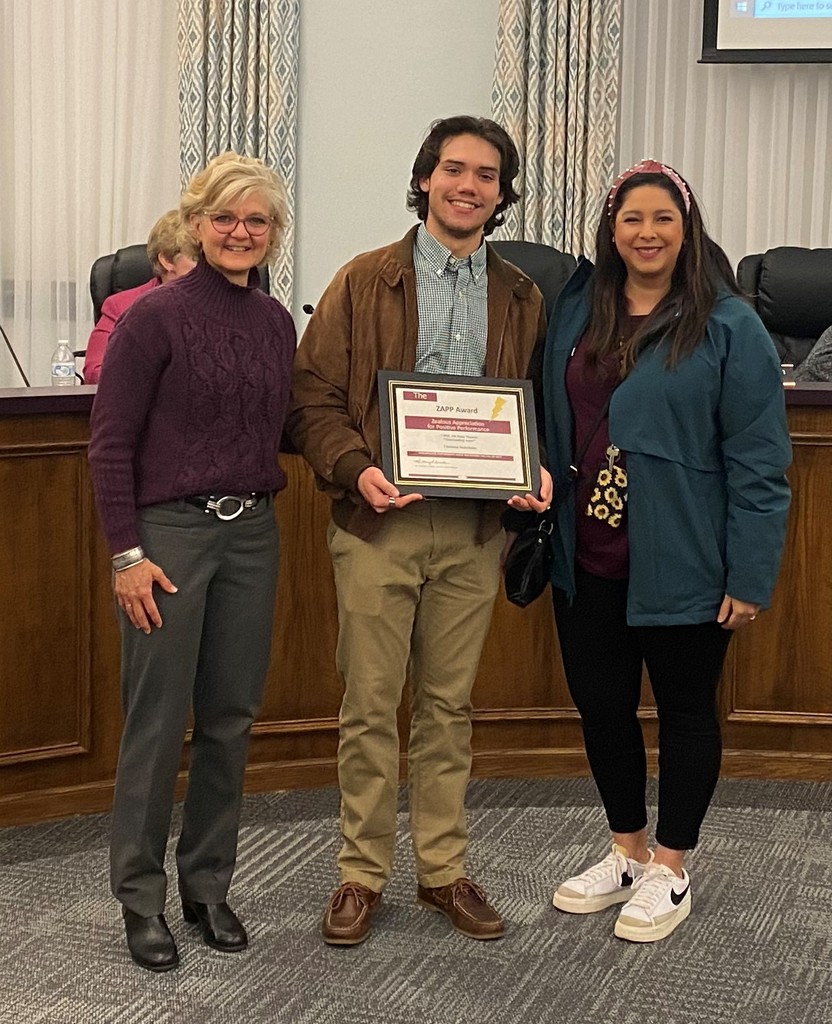student receiving award with Board member and teacher