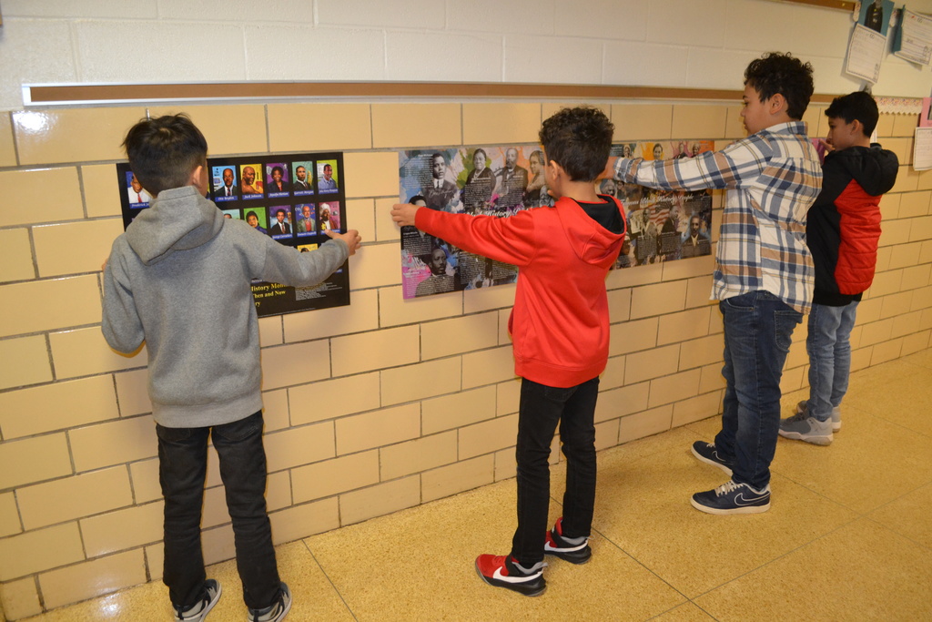 SCA Members hang posters to show Bold Leaders in Black History