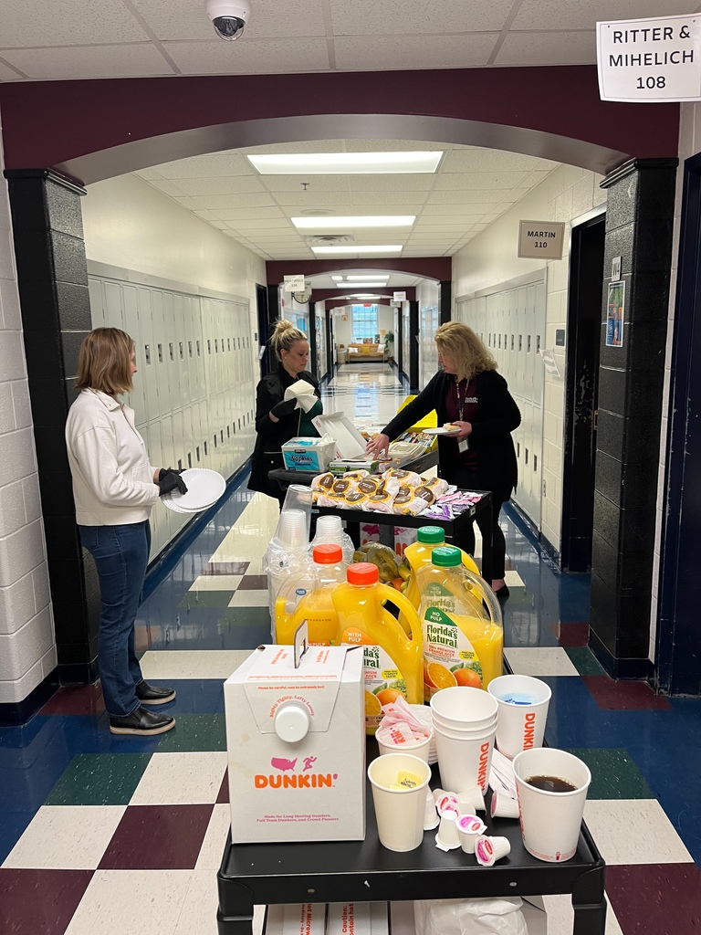 A picture of the Parent Advisory Committee delivering breakfast to an 8th grade teacher. 