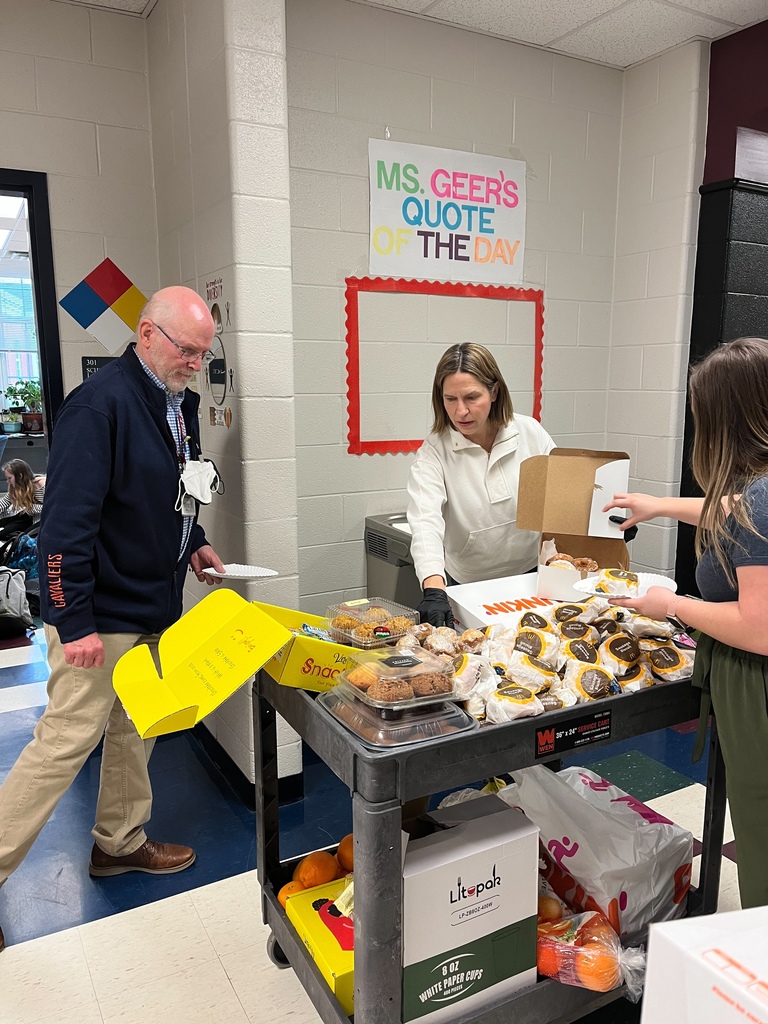 A picture of the Parent Advisory Committee delivering breakfast to a 7th grade teacher.