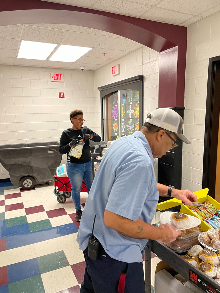 A picture of the Parent Advisory Committee delivering breakfast to a custodian.