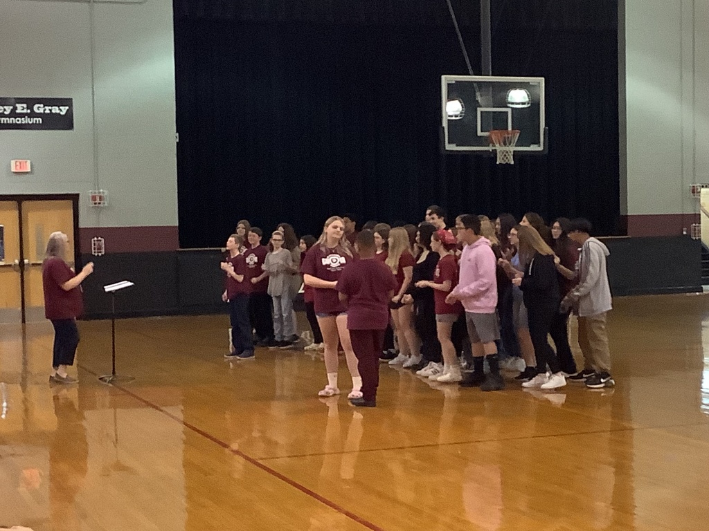 A picture of the drama club performing in the gym