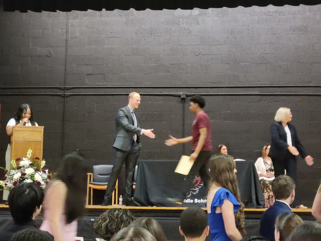 A picture of Stiver shaking another students hand