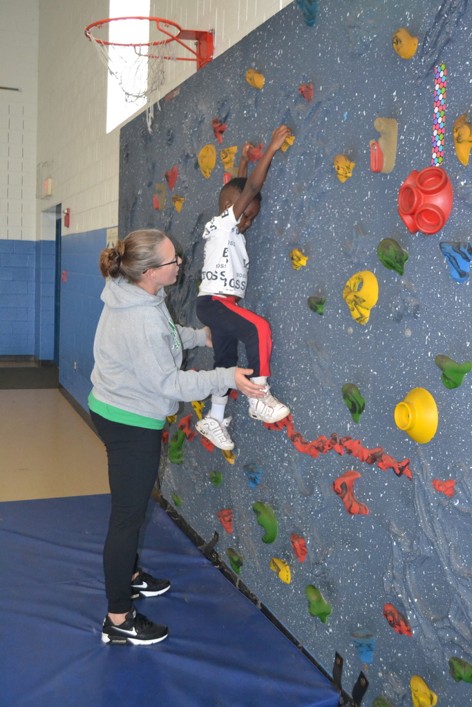 Student climbing the rock wall.