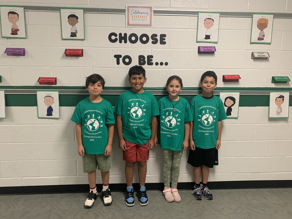 students standing in front of Choose to Be display on the wall